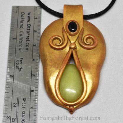 Gold polymer clay pendant with green serpentine and black onyx.