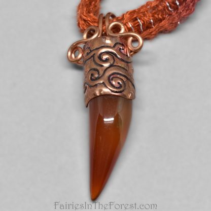 Copper and Red Agate claw pendant on a burgundy and orange necklace.