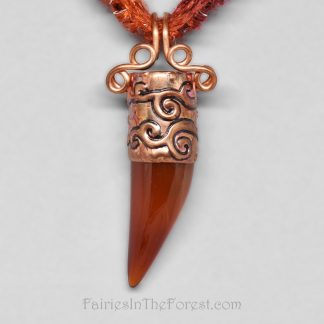 Copper and Red Agate claw pendant on a burgundy and orange necklace.