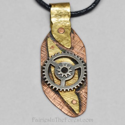 Copper and brass steampunk pendant on a black cotton necklace.