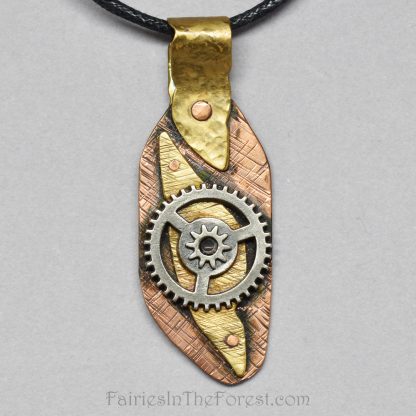 Copper and brass steampunk pendant on a black cotton necklace.